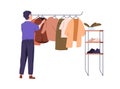 Customer shopping, choosing clothes. Person in showroom, searching apparel on hanger rail. Man shopper looking for