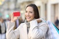 Customer showing credit card on the street in winter