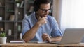 Young male student in headset confer with teacher online