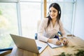 Customer support operator working in a call center office with laptop Royalty Free Stock Photo