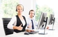 Customer support operators in formalwear working using computers Royalty Free Stock Photo