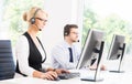 Customer support operators in formalwear working using computers Royalty Free Stock Photo