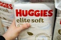 Huggies Diapers for sale in a store. The customer takes a pack of diapers from the store shelf. Minsk, Belarus 2023