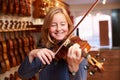 Customer Trying Out Violin In Music Store Royalty Free Stock Photo