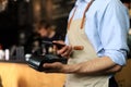 Customer using credit cart for payment to owner at cafe restaurant, cashless technology and credit card payment