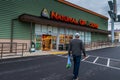 Customer walks towards Natural Grocers store