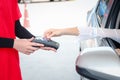 Customer woman hand holding credit card mock up and giving to gas station attendant woker for payment at gas station Royalty Free Stock Photo