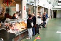 Customers at the cheesemonger in the San Agustin market in La CoruÃÂ±a