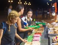 Customers choose from trays of barbecue food for sale,at night,along Rizal Boulevard