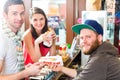 Customers eating Hotdog in fast food snack bar