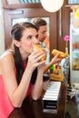 Customers eating Hotdog in fast food snack bar Royalty Free Stock Photo