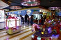 Customers enjoy games, rides, and other attractions inside a video game arcade inside a mall