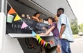 Customers or friends and saleswoman at food truck