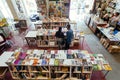 Customers of huge bookstore reading new novels, art books and magazines inside hall with bookshelves Royalty Free Stock Photo