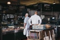 Customers inside a butcher`s stand at Borough Market, London, UK