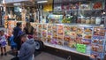 Customers line up outside a food truck at a public park in the evening, studying the menu Royalty Free Stock Photo