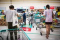 Customers line up a queue at cashier counter in Supermarket at Sukhumvit road Onnut Bangkok Thailand