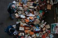 Customers look at book stand on a flea market