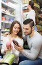 Customers near fridge with meat products Royalty Free Stock Photo