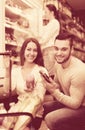 Customers near fridge with meat products Royalty Free Stock Photo