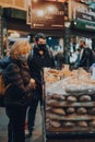 Customers at Oliviers Bakery stall inside Borough Market, London, UK