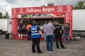 Customers queing to buy hot food at a burger vendor stall outside Royalty Free Stock Photo