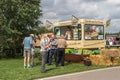 Customers queing to buy traditional ice cream from and ice cream van outside Royalty Free Stock Photo