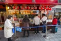 Customers queueing in front of Takoyaki octopus balls stall at Dotonburi street in Osaka, Japan