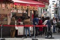 Customers queueing in front of Takoyaki octopus balls stall at Dotonburi street in Osaka, Japan