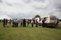 Customers queuing and buying ice cream from ice cream van at a festival