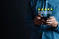 Customers rate service of Businessmen choose to rate 5 stars using smart phone and give five star symbol. Excellent rating. User