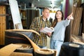 Customers shopping in building store and pointing to something Royalty Free Stock Photo