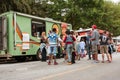 Customers Stand In Line To Buy Meals From Food Trucks Royalty Free Stock Photo