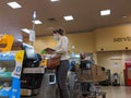 Customers wearing face masks while doing self checkout during the COVID-19 coronavirus outbreak