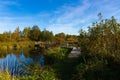 Customized, Homemade pedestrian bridge across the river. Autumn landscape Royalty Free Stock Photo