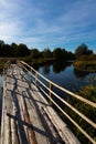 Customized, Homemade pedestrian bridge across the river. Autumn landscape Royalty Free Stock Photo