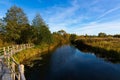 Customized, Homemade pedestrian bridge across the river. Autumn landscape Royalty Free Stock Photo