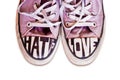 Customized used pink sneakers with words hate and love