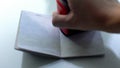 Customs officer hand stamping rectangular seal in passport, travelling, visa Royalty Free Stock Photo