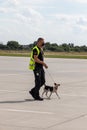 Customs officer with a service dog at airport