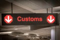 Customs sign in Airport and direction arrow, red and lighted.