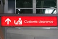 Customs sign in Airport and direction arrow, red and lighted.