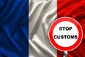 Customs sign, stop, attention against the background of the silk national flag of France, the concept of border and customs Royalty Free Stock Photo