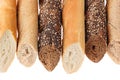 Cut baguette bread of different varieties on a white background. Rye, wheat and whole grain bread. Isolated. Decorative frame of Royalty Free Stock Photo