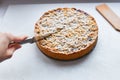 cut berry pie. slice of homemade sour cherry pie on plate and whole tart cut in slices in baking dish on napkin on wooden table, Royalty Free Stock Photo