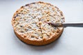 cut berry pie. slice of homemade sour cherry pie on plate and whole tart cut in slices in baking dish on napkin on wooden table, Royalty Free Stock Photo