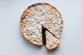 Cut berry pie. slice of homemade sour cherry pie on plate and whole tart cut in slices in baking dish on napkin on wooden table, Royalty Free Stock Photo