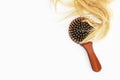 Cut blonde tangled yellow hair and massage wooden comb Royalty Free Stock Photo