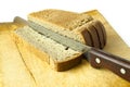 Cut bread knife on wooden kitchen board Royalty Free Stock Photo