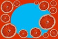 Cut bright red orange halves grapefruit slices on decorative red backdrop with light blue round Royalty Free Stock Photo